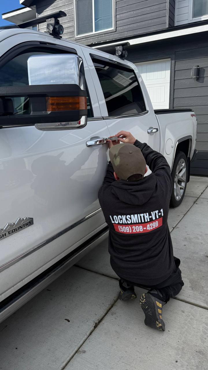 VT-1 Locksmith technician unlocking a pickup truck