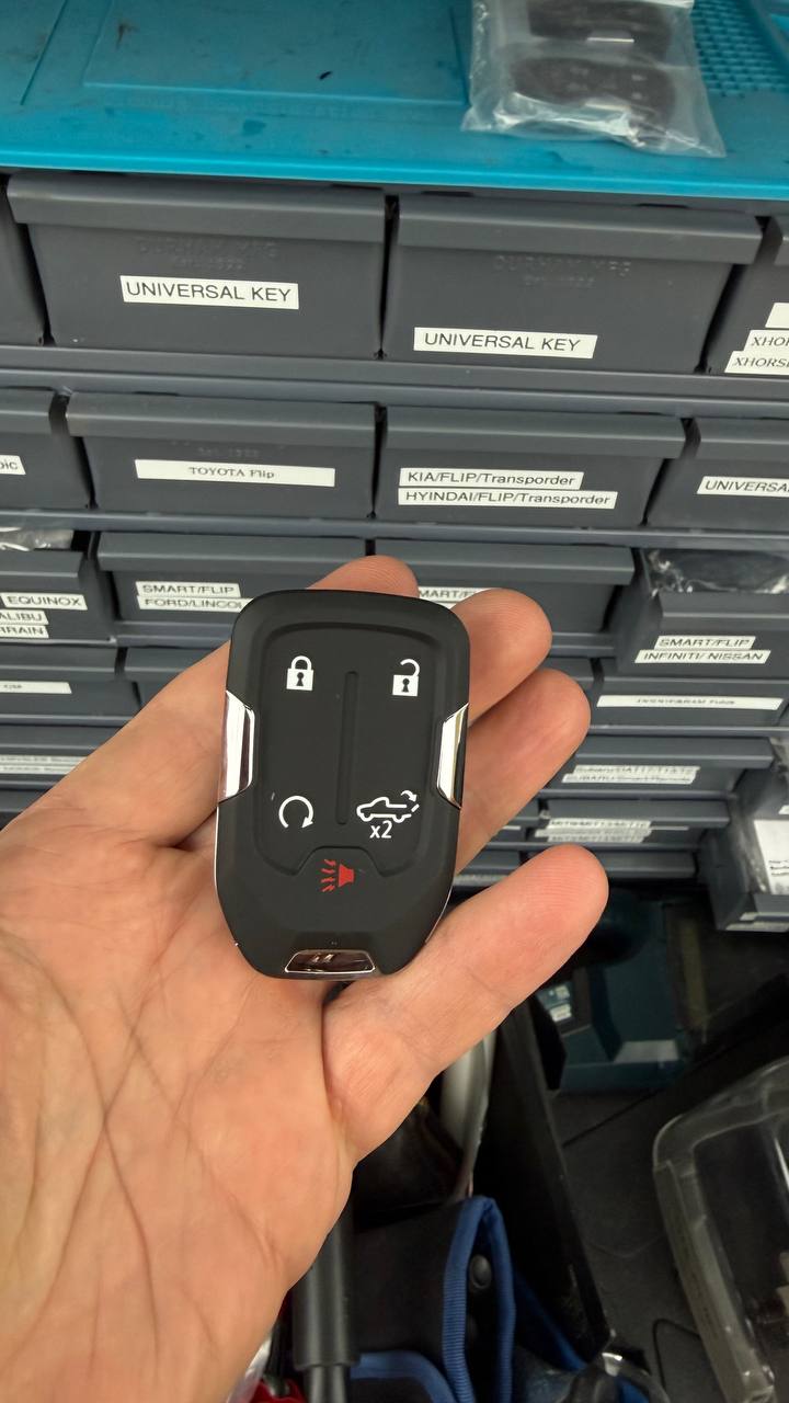 Smart key displayed beside organized automotive key supplies
